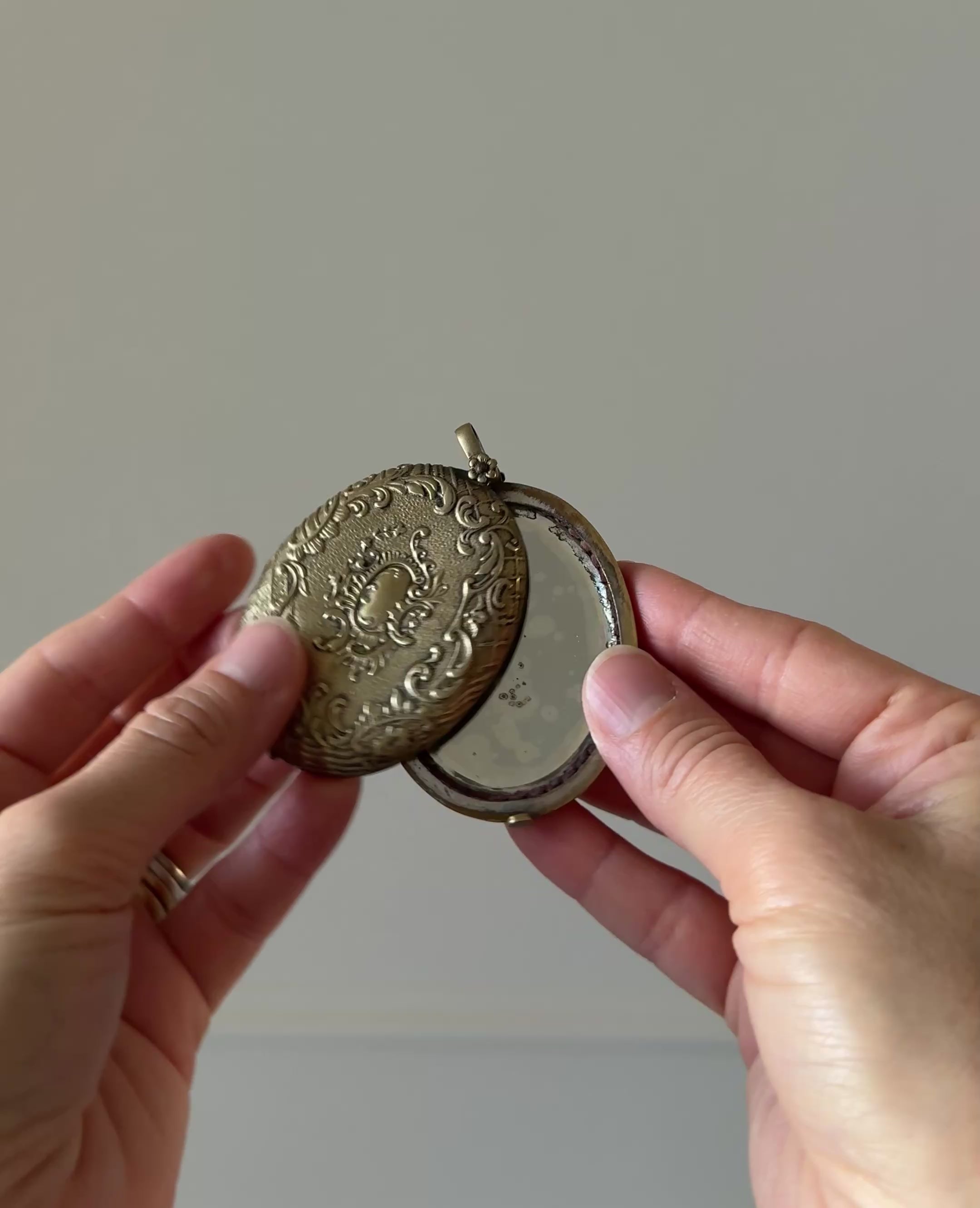 rare turn of the century French silver & brass repousse mirrored slide locket